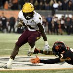 Arizona State running back Eno Benjamin, left, avoids a tackle by Oregon State defensive back Jaydon Grant during the second half of an NCAA college football game in Corvallis, Ore., Saturday, Nov. 16, 2019. (AP Photo/Steve Dykes)