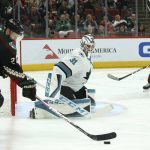 Arizona Coyotes center Derek Stepan (21) tries to shoot against San Jose Sharks goaltender Martin Jones (31) as Coyotes center Vinnie Hinostroza, right, looks on during the second period of an NHL hockey game Saturday, Nov. 30, 2019, in Glendale, Ariz. (AP Photo/Ross D. Franklin)