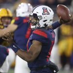 Arizona's Khalil Tate (14) looks to pass against Arizona State's defense during the first half of an NCAA college football game, Saturday, Nov. 30, 2019, in Tempe, Ariz. (AP Photo/Darryl Webb)