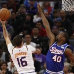 Phoenix Suns guard Tyler Johnson, left, goes to the basket against Sacramento Kings forward Harrison Barnes, right, during the first quarter of an NBA basketball game in Sacramento, Calif., Tuesday, Nov. 19, 2019. (AP Photo/Rich Pedroncelli)