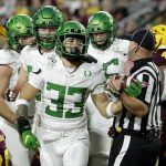 Oregon running back Cyrus Habibi-Likio (33) hands the ball to an official after his touchdown against Arizona State during the first half of an NCAA college football game Saturday, Nov. 23, 2019, in Tempe, Ariz. (AP Photo/Matt York)