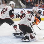 Arizona Coyotes ' goalie Darcy Kuemper (35) makes a save against Edmonton Oilers' Connor McDavid (97) as Coyotes' Jordan Oesterle (82) tries to defend during second-period NHL hockey game action in Edmonton, Alberta, Monday, Nov. 4, 2019. (Jason Franson/The Canadian Press via AP)
