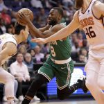 Boston Celtics guard Kemba Walker (8) drives as Phoenix Suns forward Dario Saric and center Aron Baynes (46) defend during the first half of an NBA basketball game, Monday, Nov. 18, 2019, in Phoenix. (AP Photo/Matt York)