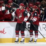 Arizona Coyotes' Christian Dvorak (18) and Clayton Keller (9) are greeted by teammates after Dvorak's first goal against the Anaheim Ducks during the first period of an NHL hockey game Wednesday, Nov. 27, 2019, in Glendale, Ariz. (AP Photo/Darryl Webb)