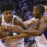 Phoenix Suns forward Kelly Oubre Jr., left, drives past Philadelphia 76ers forward Al Horford, right, during the second half of an NBA basketball game, Monday, Nov. 4, 2019, in Phoenix. The Suns defeated the 76ers 114-109. (AP Photo/Ross D. Franklin)