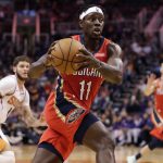 New Orleans Pelicans guard Jrue Holiday (11) drives against the Phoenix Suns during the first half of an NBA basketball game, Thursday, Nov. 21, 2019, in Phoenix. (AP Photo/Matt York)