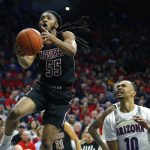 New Mexico State guard Shawn Williams (55) drives by Arizona guard Jemarl Baker Jr. in the first half of an NCAA college basketball game, Sunday, Nov. 17, 2019, in Tucson, Ariz. (AP Photo/Rick Scuteri)