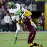 Oregon wide receiver Juwan Johnson (6) can't hold on to a pass as Arizona State defensive back Connor Soelle (18) defends during the first half of an NCAA college football game Saturday, Nov. 23, 2019, in Tempe, Ariz. (AP Photo/Matt York)