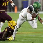 Oregon running back CJ Verdell is tackled by Arizona State safety Cam Phillips (15) during the first half of an NCAA college football game Saturday, Nov. 23, 2019, in Tempe, Ariz. (AP Photo/Matt York)