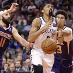 Brooklyn Nets guard Spencer Dinwiddie is fouled by Phoenix Suns forward Cameron Johnson, right, during the second half of an NBA basketball game Sunday, Nov. 10, 2019, in Phoenix. (AP Photo/Matt York)