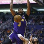 Los Angeles Lakers forward Anthony Davis dunks over Phoenix Suns guard Ricky Rubio (11) in the first half during an NBA basketball game, Tuesday, Nov. 12, 2019, in Phoenix. (AP Photo/Rick Scuteri)