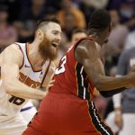 Phoenix Suns' Aron Baynes (46) plays tight defense against Miami Heat's Bam Adebayo (13) during the second half of an NBA basketball game Thursday, Nov. 7, 2019, in Phoenix. (AP Photo/Darryl Webb)