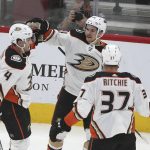 Anaheim Ducks' Sam Steel (34) gets a high five from teammates Cam Fowler (4) and Nick Ritchie (37) after scoring a goal against the Arizona Coyotes during the second period of an NHL hockey game Wednesday, Nov. 27, 2019, in Glendale, Ariz. (AP Photo/Darryl Webb)