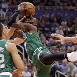Boston Celtics guard Kemba Walker gets tangled with Phoenix Suns forward Dario Saric for a jump ball during the first half of an NBA basketball game, Monday, Nov. 18, 2019, in Phoenix. (AP Photo/Matt York)