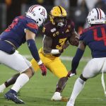 Arizona State's Eno Benjamin (3) is defended by Arizona's Anthony Pandy (8) and Christian Roland-Wallace (4) during the first half of an NCAA college football game, Saturday, Nov. 30, 2019, in Tempe, Ariz. (AP Photo/Darryl Webb)