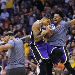 Los Angeles Lakers forward Kyle Kuzma (0) celebrates with teammates after defeating the Phoenix Suns 123-115 during an NBA basketball game, Tuesday, Nov. 12, 2019, in Phoenix. (AP Photo/Rick Scuteri)