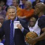 Philadelphia 76ers head coach Brett Brown, left, argues with referee Tom Washington, right, during the first half of an NBA basketball game against the Phoenix Suns, Monday, Nov. 4, 2019, in Phoenix. (AP Photo/Ross D. Franklin)
