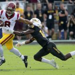 Southern California wide receiver Amon-Ra St. Brown (8) eludes the tackle of Arizona State safety Cam Phillips (15) during the first half of an NCAA college football game, Saturday, Nov. 9, 2019, in Tempe, Ariz. (AP Photo/Matt York)