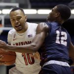 Arizona guard Jemarl Baker Jr., left, is defended by Pennsylvania guard Devon Goodman while driving to the basket during the second half of an NCAA college basketball game at the Wooden Legacy tournament in Anaheim, Calif., Friday, Nov. 29, 2019. (AP Photo/Alex Gallardo)