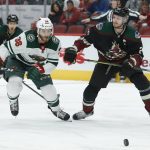 Minnesota Wild right wing Ryan Hartman (38) and Arizona Coyotes defenseman Oliver Ekman-Larsson chase the puck in the first period during an NHL hockey game, Saturday, Nov. 9, 2019, in Glendale, Ariz. (AP Photo/Rick Scuteri)