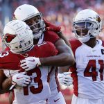 Arizona Cardinals wide receiver Larry Fitzgerald, center, celebrates with wide receiver Christian Kirk (13) and running back Kenyan Drake (41) after scoring against the San Francisco 49ers during the first half of an NFL football game in Santa Clara, Calif., Sunday, Nov. 17, 2019. (AP Photo/Josie Lepe)
