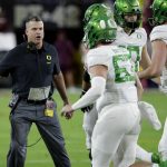 Oregon coach Mario Cristobal greets his team after a touchdown during the first half of an NCAA college football game against Arizona State, Saturday, Nov. 23, 2019, in Tempe, Ariz. (AP Photo/Matt York)