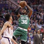 Boston Celtics guard Marcus Smart (36) shoots over Phoenix Suns guard Devin Booker during the first half of an NBA basketball game, Monday, Nov. 18, 2019, in Phoenix. (AP Photo/Matt York)