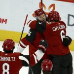 Arizona Coyotes center Carl Soderberg (34) celebrates his goal against the Edmonton Oilers with Coyotes defenseman Jakob Chychrun (6) and Coyotes center Nick Schmaltz (8) during the first period of an NHL hockey game Sunday, Nov. 24, 2019, in Glendale, Ariz. (AP Photo/Ross D. Franklin)