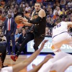 Phoenix Suns forward Mikal Bridges drives to the basket as Phoenix Suns center Aron Baynes, right, falls during the first half of an NBA basketball game Thursday, Nov. 14, 2019, in Phoenix. (AP Photo/Matt York)