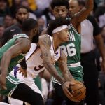 Phoenix Suns forward Kelly Oubre Jr., center, drives as Boston Celtics guard Jaylen Brown, left, and guard Marcus Smart, right, defend during the first half of an NBA basketball game, Monday, Nov. 18, 2019, in Phoenix. (AP Photo/Matt York)