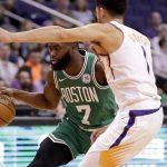 Boston Celtics guard Jaylen Brown (7) drives as Phoenix Suns guard Devin Booker (1) defends during the first half of an NBA basketball game, Monday, Nov. 18, 2019, in Phoenix. (AP Photo/Matt York)