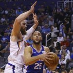 Philadelphia 76ers guard Ben Simmons (25) drives to the basket against Phoenix Suns center Aron Baynes, left, during the first half of an NBA basketball game Monday, Nov. 4, 2019, in Phoenix. (AP Photo/Ross D. Franklin)