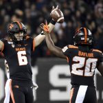 Oregon State quarterback Jake Luton and running back B.J. Baylor celebrate as the clock runs out in an NCAA college football game agains Arizona State in Corvallis, Ore., Saturday, Nov. 16, 2019. (AP Photo/Steve Dykes)