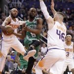 Boston Celtics guard Kemba Walker (8) has the ball stripped by Phoenix Suns guard Jevon Carter during the first half of an NBA basketball game, Monday, Nov. 18, 2019, in Phoenix. (AP Photo/Matt York)