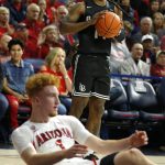 Long Beach State guard Colin Slater, top, reacts after getting called for an offensive foul against Arizona guard Nico Mannion, bottom, in the first half during an NCAA college basketball game, Sunday, Nov. 24, 2019, in Tucson, Ariz. (AP Photo/Rick Scuteri)