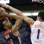 Phoenix Suns guard Devin Booker (1) pressures Washington Wizards guard Ish Smith (14) in the first half during an NBA basketball game, Wednesday, Nov. 27, 2019, in Phoenix. (AP Photo/Rick Scuteri)