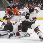 Arizona Coyotes ' Jakob Chychrun (6) picks up a rebound from goalie Darcy Kuemper (35) as Edmonton Oilers' Connor McDavid (97) looks for the puck during second-period NHL hockey game action in Edmonton, Alberta, Monday, Nov. 4, 2019. (Jason Franson/The Canadian Press via AP)