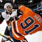 Arizona Coyotes ' Jordan Oesterle (82) checks Edmonton Oilers' Gaetan Haas (91) during second-period NHL hockey game action in Edmonton, Alberta, Monday, Nov. 4, 2019. (Jason Franson/The Canadian Press via AP)