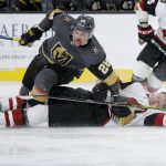 Arizona Coyotes right wing Christian Fischer, right, falls against Vegas Golden Knights left wing William Carrier (28) during the third period of an NHL hockey game Friday, Nov. 29, 2019, in Las Vegas. (AP Photo/John Locher)