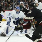 Toronto Maple Leafs goaltender Frederik Andersen (31) makes a save on a shot by Arizona Coyotes Conor Garland, right, during the third period of an NHL hockey game Thursday, Nov. 21, 2019, in Glendale, Ariz. The Maple Leafs won 3-1. (AP Photo/Ross D. Franklin)