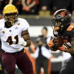Oregon State running back Artavis Pierce runs with the ball as Arizona State defensive lineman Tyler Johnson closes in during the first half of an NCAA college football game in Corvallis, Ore., Saturday, Nov. 16, 2019. (AP Photo/Steve Dykes)