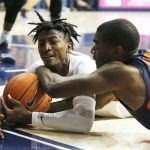 Arizona guard Dylan Smith, left, and Illinois guard Da'Monte Williams (20) scramble for the ball durikng the first half of an NCAA college basketball game Sunday, Nov. 10, 2019, in Tucson, Ariz. (AP Photo/Rick Scuteri)