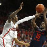 Illinois guard Andres Feliz (10) shoots over Arizona guard Dylan Smith during the first half of an NCAA college basketball game Sunday, Nov. 10, 2019, in Tucson, Ariz. (AP Photo/Rick Scuteri)