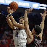 Arizona center Chase Jeter (4) shoots over New Mexico State forward Ivan Aurrecoechea in the second half of an NCAA college basketball game, Sunday, Nov. 17, 2019, in Tucson, Ariz. (AP Photo/Rick Scuteri)