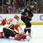 Calgary Flames goaltender David Rittich (33) makes a save on a shot by Arizona Coyotes center Carl Soderberg (34) during the second period of an NHL hockey game, Saturday, Nov. 16, 2019, in Glendale, Ariz. (AP Photo/Ross D. Franklin)
