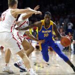 San Jose State guard Omari Moore (10) drives on Arizona's Jemarl Baker Jr. and Stone Gettings (13) during the first half of an NCAA college basketball game Thursday, Nov. 14, 2019, in Tucson, Ariz. (AP Photo/Rick Scuteri)