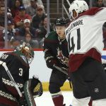 Arizona Coyotes goaltender Darcy Kuemper (35) makes a save between Colorado Avalanche left wing Pierre-Edouard Bellemare (41) and Coyotes defenseman Aaron Ness (42) during the first period of an NHL hockey game Saturday, Nov. 2, 2019, in Glendale, Ariz. (AP Photo/Ross D. Franklin)