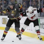 Vegas Golden Knights right wing Mark Stone (61) and Arizona Coyotes defenseman Jakob Chychrun (6) vie for the puck during overtime in an NHL hockey game Friday, Nov. 29, 2019, in Las Vegas. (AP Photo/John Locher)
