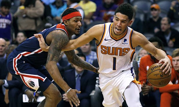Phoenix Suns guard Devin Booker (1) drives on Washington Wizards guard Bradley Beal in the second h...