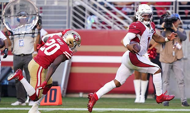 Quarterback Kyler Murray #1 of the Arizona Cardinals carries the football en route to scoring on a ...